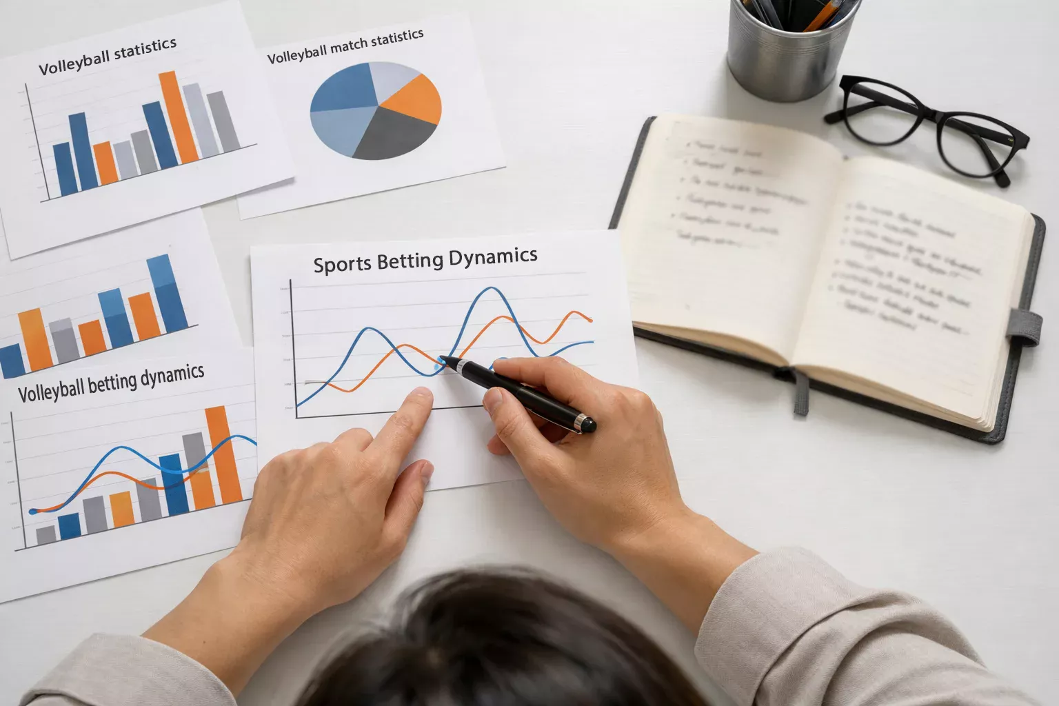 Persona analizza dati statistici su fogli stampati con grafici lineari su una scrivania
